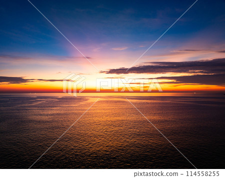 Aerial view sunset sky, Beautiful Light Sunset or sunrise over sea,Colorful dramatic majestic scenery sunset Sky, Amazing clouds and small waves in the ocean, Wonderful light cloud background 114558255