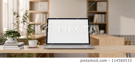 A laptop computer mockup on a wooden tabletop in a contemporary minimalist cafe co-working space. A laptop computer mockup on a wooden tabletop in a contemporary minimalist cafe co-working space. 114560533