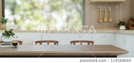 A wooden dining table with copy space for displaying products is in a contemporary kitchen. 114560649