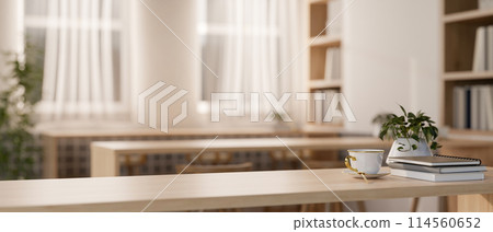 A space for displaying products on a wooden tabletop in a cozy contemporary library reading room. A space for displaying products on a wooden tabletop in a cozy contemporary library reading room. 114560652