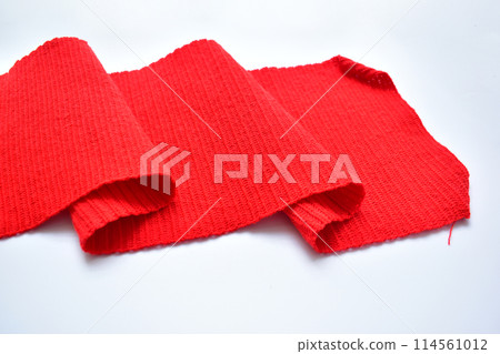 wavy of red wool knitted yarn texture, woolen fabric on white background wavy of red wool knitted yarn texture, woolen fabric on white background 114561012