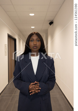 Commanding Presence: Young Black Woman in Pinstripe Blazer Commanding Presence: Young Black Woman in Pinstripe Blazer 114561390
