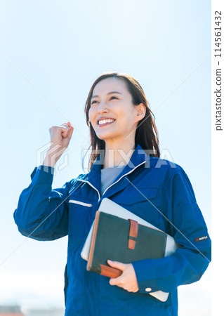 A young woman working in the logistics industry fist-pumping A young woman working in the logistics industry fist-pumping 114561432