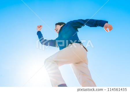 A man in his 30s working at a logistics center jumping A man in his 30s working at a logistics center jumping 114561435