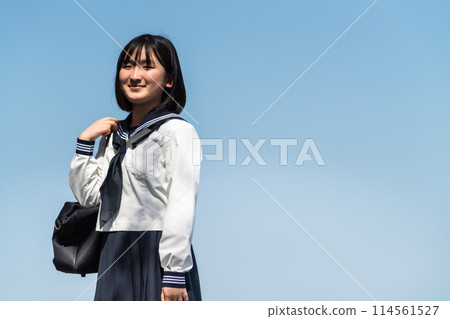 A high school girl going to school on a sunny day 114561527