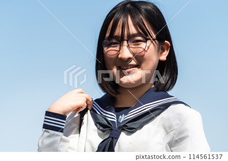 A high school girl going to school on a sunny day 114561537