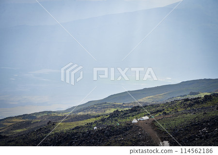 Mountain tent campsite set on the side of the mountain hit by soft noon light, Mount Ararat Turkey 114562186