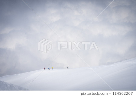 Mountaineers going down the snowy ridgeline with clouds in backdrop, Mount Ararat in Turkey 114562207