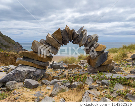 Small rocks stacked in an arch (Three Cliffs Bay, Wales, UK) Small rocks stacked in an arch (Three Cliffs Bay, Wales, UK) 114562539