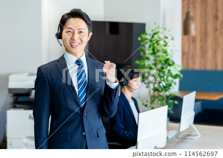 Businessman working in a call center 114562697