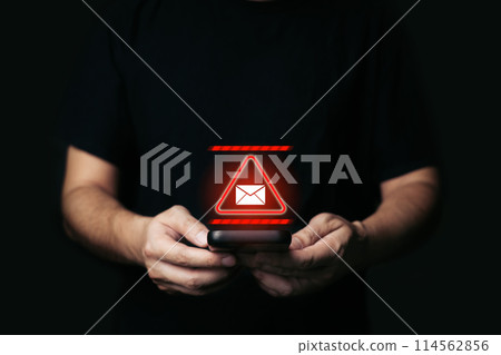 Man Holding smartphone with alert Email inbox and spam virus with warning caution for notification on internet letter security protect, junk and trash mail and compromised information. Man Holding smartphone with alert Email inbox and spam virus with warning caution for notification on internet letter security protect, junk and trash mail and compromised information. 114562856