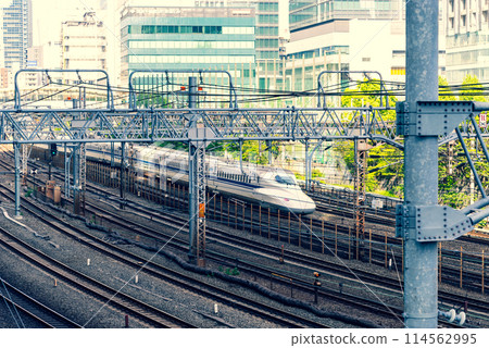 Tokyo's railway scene: The Tokaido Shinkansen running parallel to conventional lines, emphasizing warm and cool colors 114562995