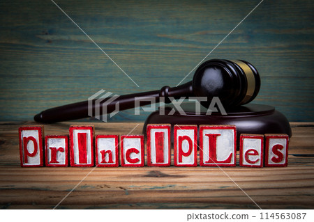PRINCIPLES. Red alphabet letters and judge's gavel on wooden background. Laws and justice concept 114563087