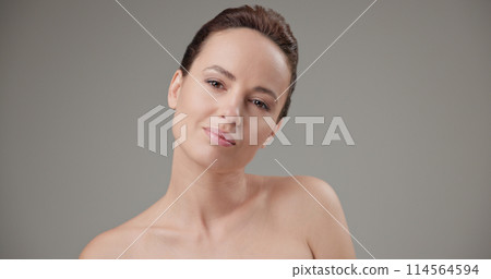 Beauty, health, cosmetics, anti-aging therapy and skin care concept - young beautiful brunette Caucasian woman standing in front of the camera and posing Beauty, health, cosmetics, anti-aging therapy and skin care concept - young beautiful brunette Caucasian woman standing in front of the camera and posing 114564594