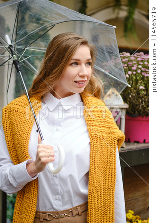 Autumn portrait of a young woman with an umbrella 114565719