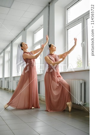 Ballet dancers rehearsing moves in the hallway Ballet dancers rehearsing moves in the hallway 114565722