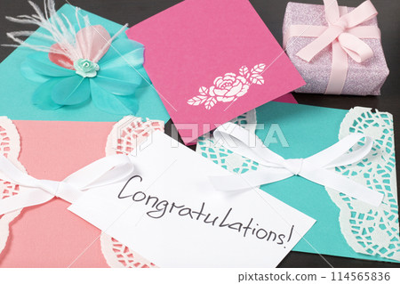 Handmade greeting cards. Near gift in wrapping paper, tied with a ribbon. Original gift. 114565836