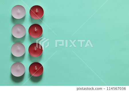 Decorative candles arranged in a row. On a mint background. Decorative candles arranged in a row. On a mint background. 114567036