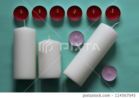 Decorative candles arranged in a row. On a mint background. Decorative candles arranged in a row. On a mint background. 114567045