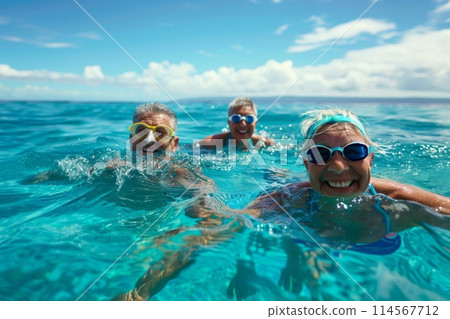 Cheerful family with snorkeling goggles swimming in the clear blue ocean Cheerful family with snorkeling goggles swimming in the clear blue ocean 114567712