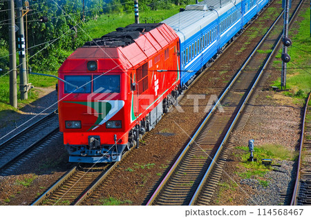 The locomotive pulling a passenger train cars 114568467