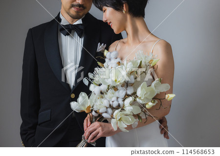 Woman in wedding dress and man in tuxedo Woman in wedding dress and man in tuxedo 114568653