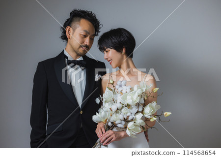 Woman in wedding dress and man in tuxedo Woman in wedding dress and man in tuxedo 114568654