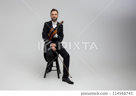 Bearded violinist with instrument classical music at concert 114568745