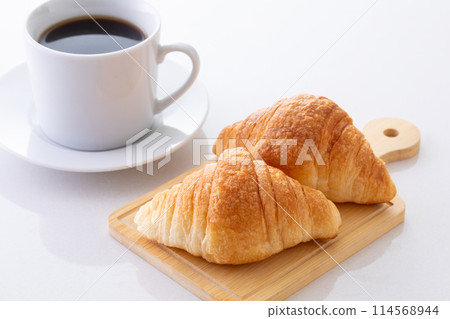 Mini croissants and hot coffee 114568944
