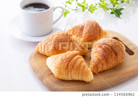 Mini croissants and hot coffee 114568962