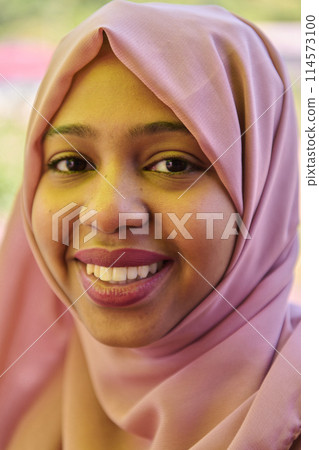 Close up Portrait of a Joyful Middle Eastern Hijabi 114573100