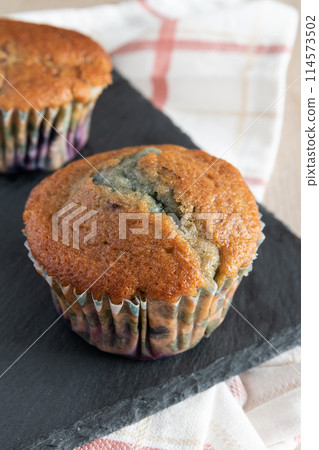 Delicious homemade blueberry muffin rustic background Delicious homemade blueberry muffin rustic background 114573502