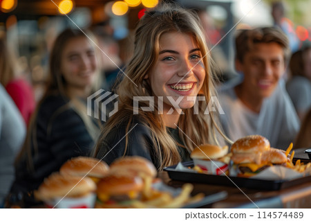 Group of Caucasians eating fast food in a restaurant. 114574489