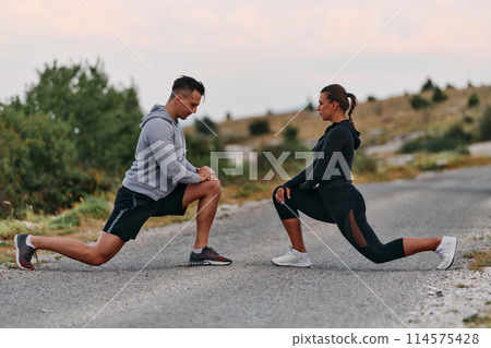 A Romantic Couple Stretching Down After a Run 114575428