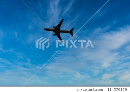 An airplane flying over the sky An airplane flying over the sky 114576159