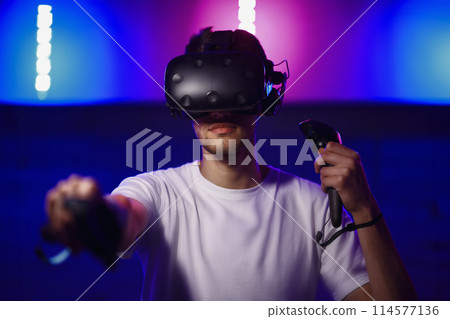 The player plays the game using virtual reality. Neon style. 114577136