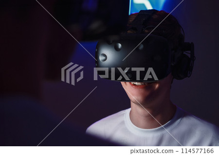 The player plays the game using virtual reality. Neon style. 114577166