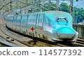A Shinkansen train passing through Nasushiobara Station at high speed 114577392