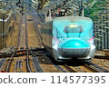 A Shinkansen train passing through Nasushiobara Station at high speed 114577395