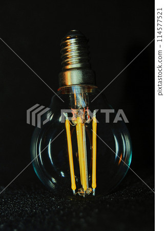 Decorative light bulb with yellow spirals. 114577521