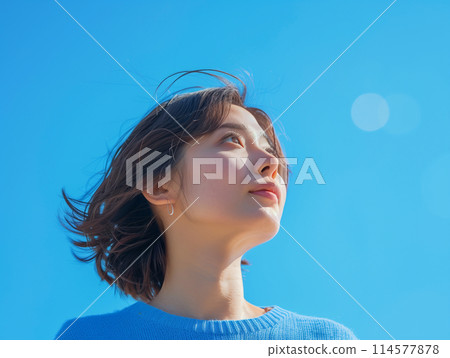 A woman looking up at the sky 114577878