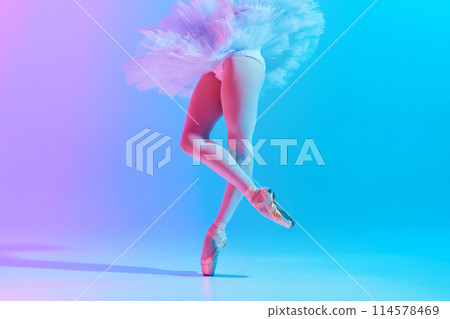 Cropped photo of young, slim ballet dancer in white tutu and pointe performing dance moves in neon light against vivid gradient background. 114578469