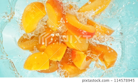 Freeze Motion of Peach Slices Falling into Water, Splashing. Freeze Motion of Peach Slices Falling into Water, Splashing. 114578945