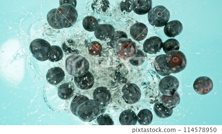 Freeze Motion of Blueberries Falling into Water, Splashing. 114578950