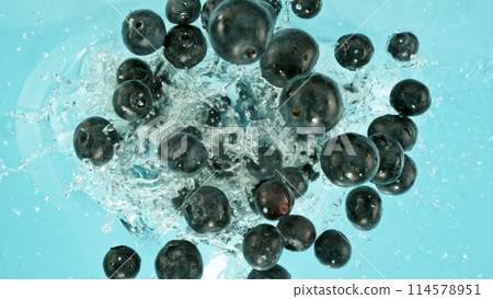 Freeze Motion of Blueberries Falling into Water, Splashing. 114578951