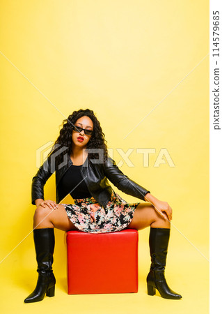 Seductive african woman posing in black bodysuit and jacket in studio. Fit sporty female. Seductive african woman posing in black bodysuit and jacket in studio. Fit sporty female. 114579685