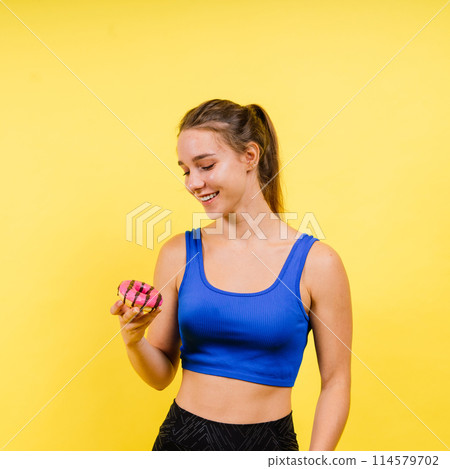 Portrait of beautiful female with chocolate donuts enjoying and looking at camera Portrait of beautiful female with chocolate donuts enjoying and looking at camera 114579702
