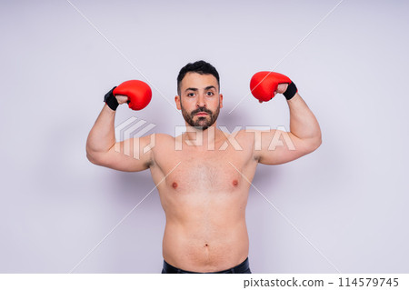 A man boxing with red gloves on his hands. Professional fighter, boxer. 114579745