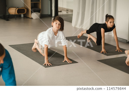 Children do Yoga in the fitness room. Children's gymnastics 114579844