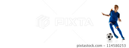 Teenager, female soccer player in blue uniform in motion with ball, practicing isolated on white studio background Teenager, female soccer player in blue uniform in motion with ball, practicing isolated on white studio background 114580253